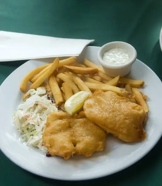Fried fish with french fries and coleslaw.