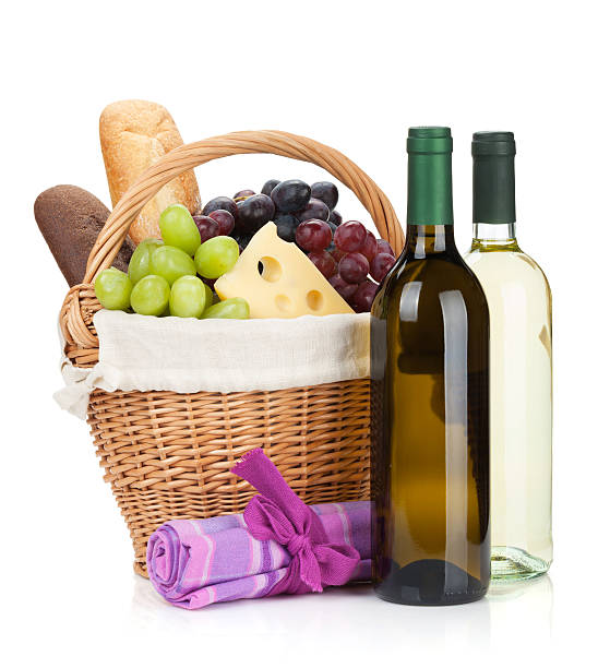 istock Picnic basket with bread, cheese, grape and wine bottles 186134463