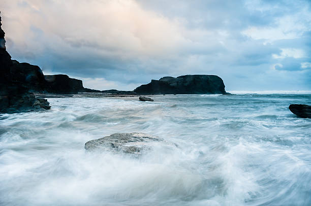 istock Stormy wave swept beach with black Saltwick Nab  Yorkshire coast 186134543