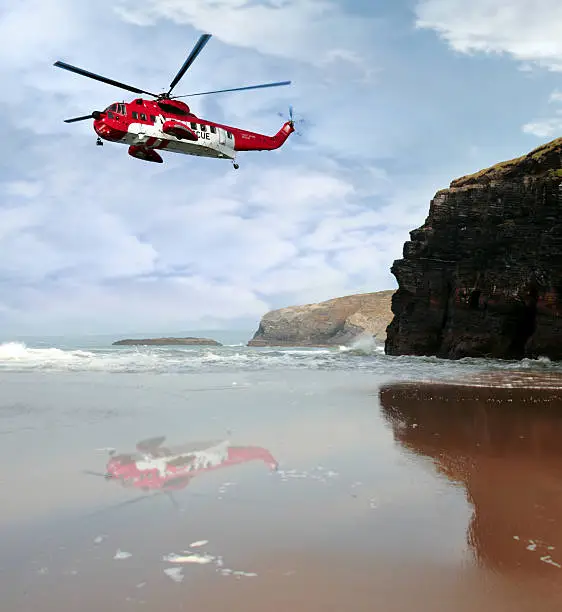 a sea rescue helicopter searching for person near to the cliffs on search and rescue mission in ballybunion county kerry ireland