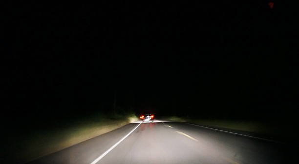 istock Light of car backlights a nightly road 186136401