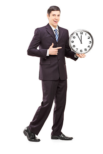 istock Young man in suit pointing on a clock 186137138