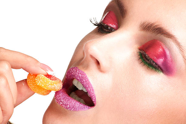istock close up of  young beautiful model enjoying a sugar candy 186137384