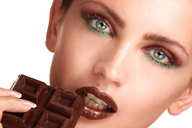istock close up of a beautiful model tasting dark chocolate 186137391