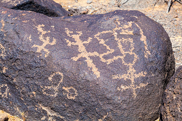 Tropical scenery of the Eastern Islands in Chile. Ancient drawing of a Manutara bird on a stone wall
