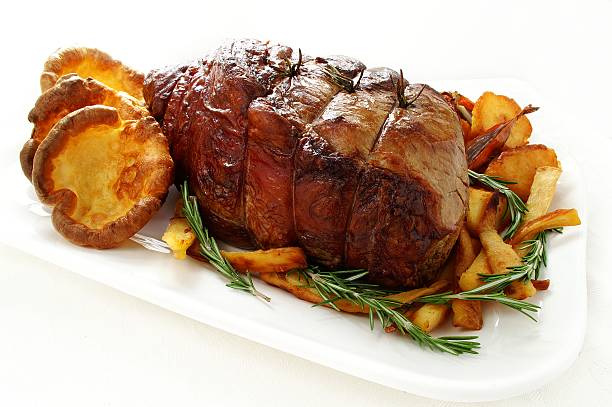istock roast beef joint with yorkshire pudding and vegetables 186138179