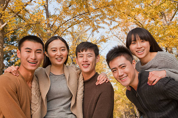 istock Young people playing piggyback in park 186139755