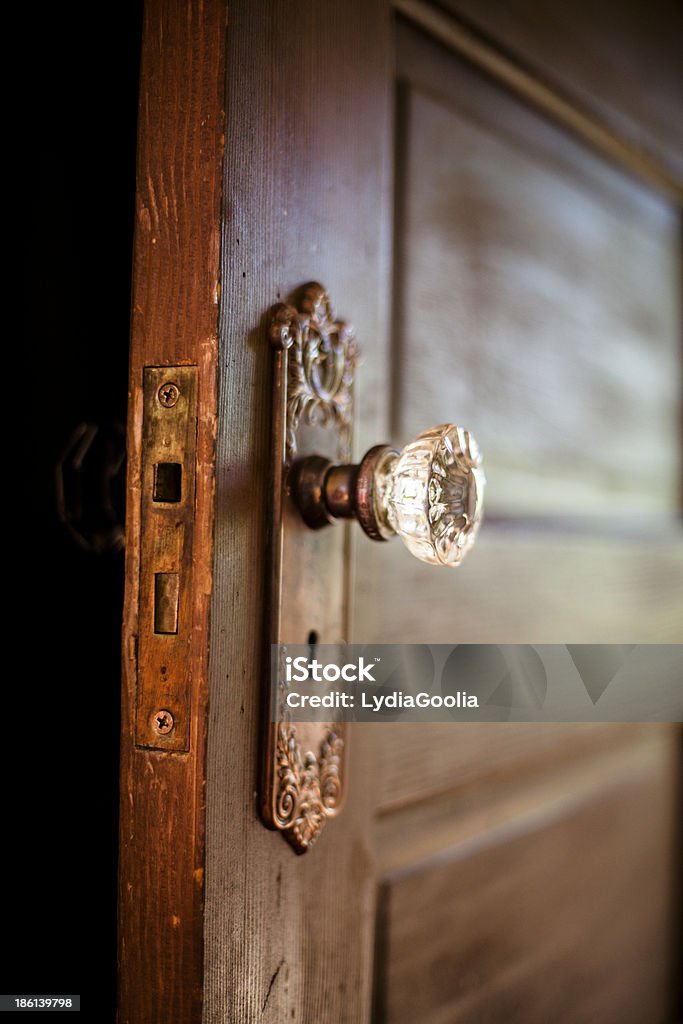 Crystal Door Knob A weathered old wooden door with an ornate crystal door knob.  Door Stock Photo