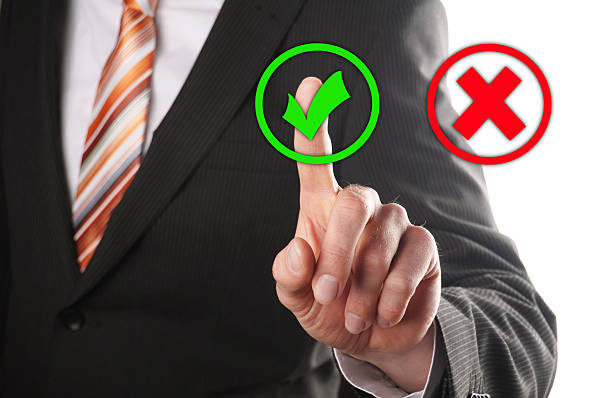 istock Man in suit selecting a green check mark not the red x 186139871
