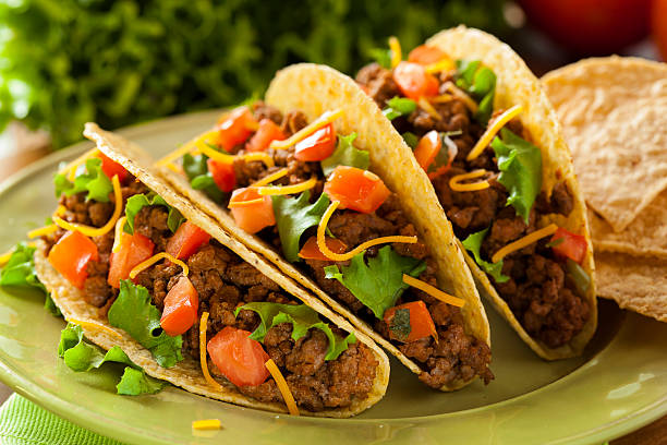 Homemade Ground Beef Tacos Homemade Ground Beef Tacos with Lettuce, Tomato, and Cheese ground beef photos stock pictures, royalty-free photos & images