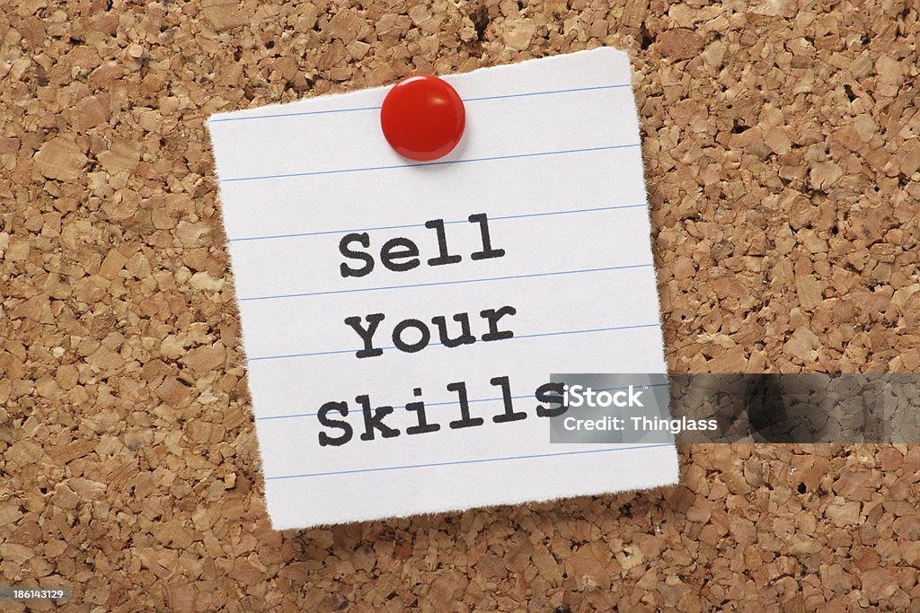 Sell Your Skills The phrase Sell Your Skills  typed onto a scrap of lined paper and pinned to a cork notice board. The ability to demonstrate out talents is essential for career success and your job search. Bulletin Board Stock Photo