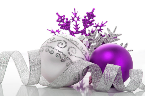 Purple and silver christmas decoration with (snowflakes, balls, ribbon ect.). Horizontal composition. Space for text.