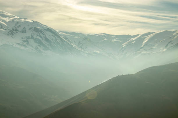 istock snowy mountain landscape and fog 1861446020