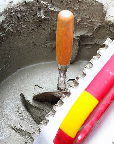 istock dirty trowel and bucket on building site 186145804