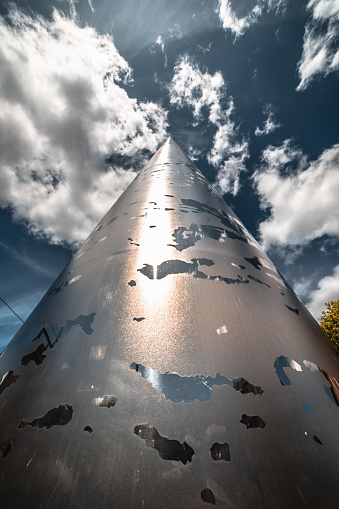 The Spire monument on the streets of Dublin from a low-angle view. The photograph captures the awe-inspiring stainless steel tapered column, reflecting the brilliance of the sun, while a backdrop of blue skies adorned with billowing clouds adds to the dynamic composition.

In this high-resolution image, The Spire's sleek and towering form extends gracefully towards the heavens, reflecting the radiant sunlight that bathes the iconic structure. The play of light on the stainless steel surface creates a mesmerizing visual spectacle, evoking a sense of modernity and aspiration. Ideal for a diverse range of creative projects, from travel magazines and architectural features to designs celebrating urban landmarks.
