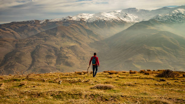 istock man doing activity in foggy and snowy mountain landscape 1861472801