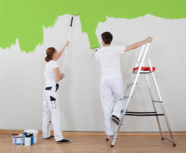 istock Young Couple Painting Wall 186148875