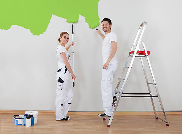 istock Young Couple Painting Wall 186148876