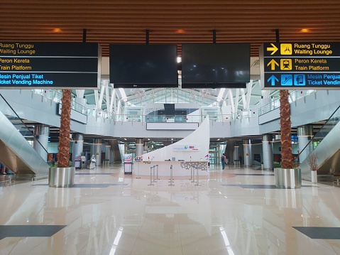 Jakarta, Indonesia - 11-29-2023: Situation at lobby in Soekarno Hatta Airport Station. Not too crowded with many people. Signboards direct to train platform, ticket vending machine, and waiting lounge