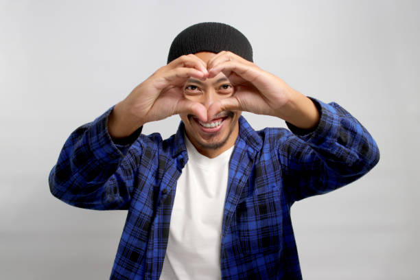 istock Asian man is making a heart gesture with his hand 1861535864