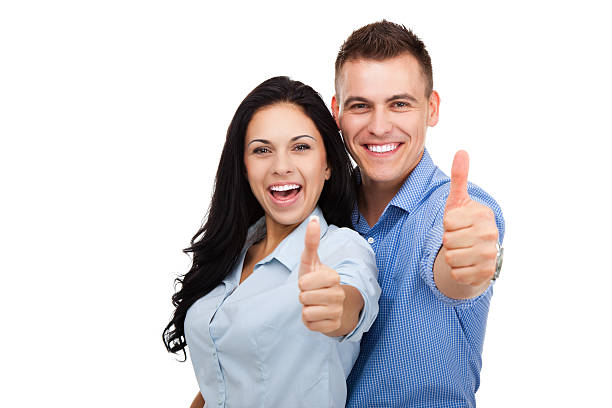 Smiling man and woman with thumbs up isolated on white happy couple love excited smiling holding thumb up gesture, beautiful young man and woman smile looking at camera, isolated over white background couple isolated wife husband stock pictures, royalty-free photos & images