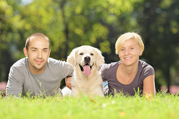 istock Smiling couple hugging their dog in a park 186156878