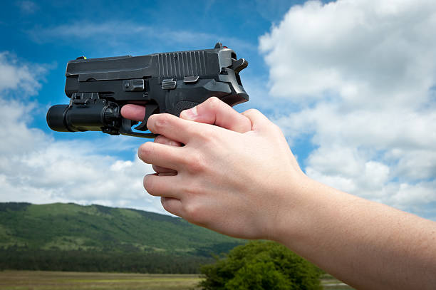 istock Hands aiming a gun in the distance 186159881