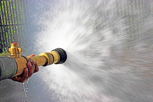 Firefighter fighting For A Fire Attack, Firefighter fighting For A Fire Attack, During A Training Exercise fire hose photos stock pictures, royalty-free photos & images