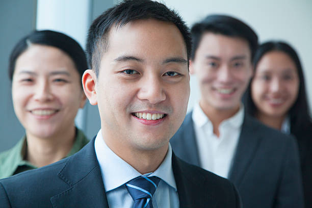 istock Businessman with co-workers in office portrait 186162120