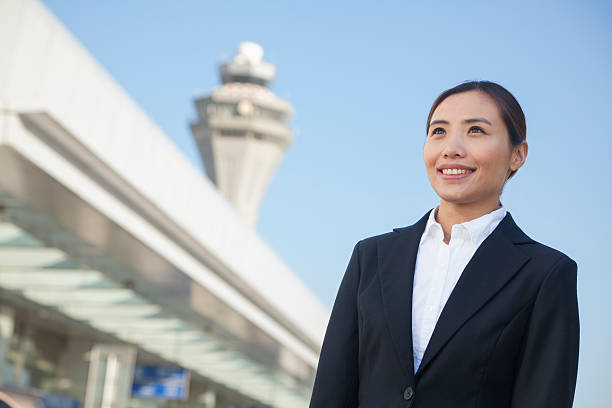 viaggiatori guardando il cielo in aeroporto - ponytail brown hair tourist women foto e immagini stock