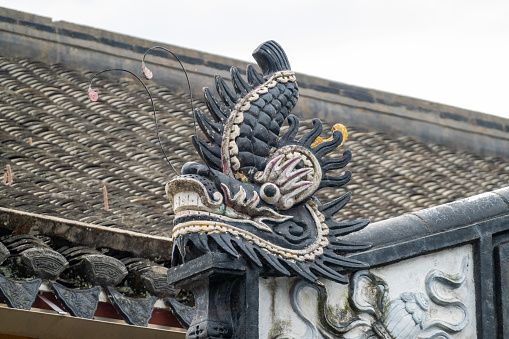 Traditional Chinese dragon sculpture on the roof of a temple in China.