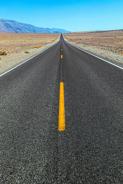 istock Death Valley road straight across the desert 186164885
