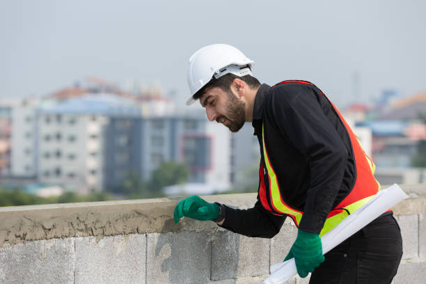 istock Foreman builder male at construction site. Male engineer inspecting work on blueprint at construction site, wearing safety uniform, helmet 1861677192