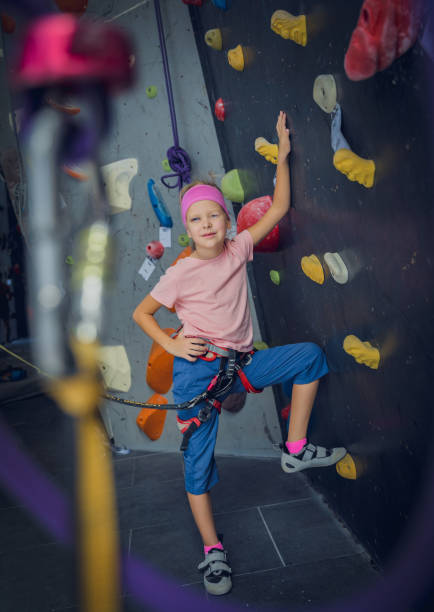 istock A strong baby climber posing for photographer at artificial wall. 1861688501