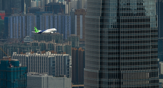 December 16, 2023, Hong Kong: C919 aircraft, one of the new passenger jets made in China, conducts a demonstration flight over Victoria Harbour. The C919 visits Hong Kong for the first time in December 2023. This is the C919's first voyage out of mainland China.