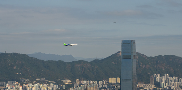 December 16, 2023, Hong Kong: C919 aircraft, one of the new passenger jets made in China, conducts a demonstration flight over Victoria Harbour. The C919 visits Hong Kong for the first time in December 2023. This is the C919's first voyage out of mainland China.