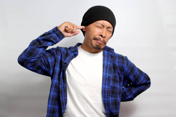 istock Asian man is inserting a finger into his ear 1861714054