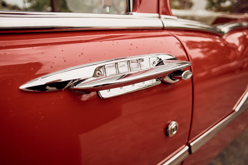 Miami, Florida USA - March 12, 2017: Close up view of the front end of a beautifully restored vintage 1956 Cadillac Series 62 convertible automobile at a public car show along Palmetto Bay in Miami.