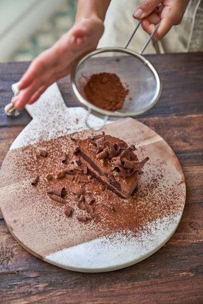 istock Crop woman preparing chocolate cake with cocoa powder 1861720199