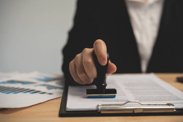 istock Close up businesswoman's Hand stamping with Approved Stamp On Document At the office table, notary or business people work from home. business working or lawyer concept. 1861725340