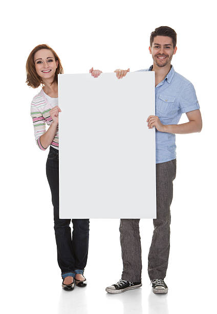 istock Young Couple Holding Blank Placard 186174509