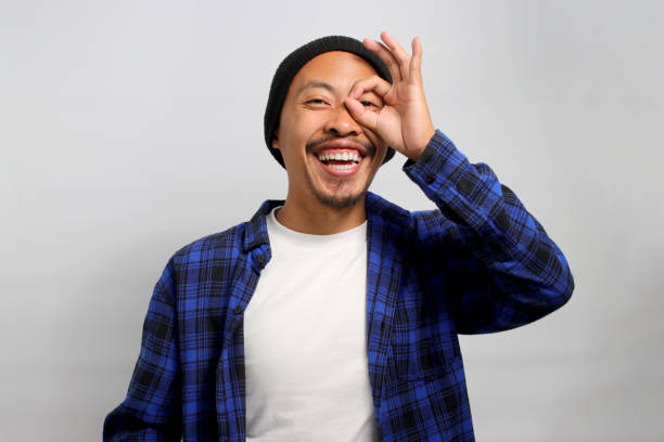 istock Asian man is making an OK gesture like binoculars 1861754854