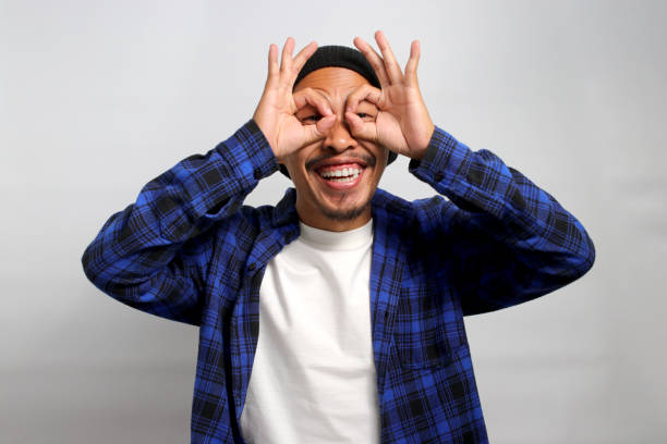istock Asian man is making an OK gesture like binoculars 1861762761