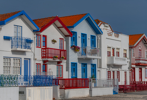 Street with colorful houses in Costa Nova, Aveiro, Portugal. Street with striped houses, Costa Nova, Aveiro, Portugal. Facades of colorful houses in Costa Nova, Aveiro, Portugal.