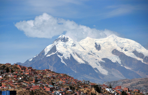 La Paz, Bolivia: southern suburbs and mount llimani  - orogenic cloud formation - photo by M.Torres