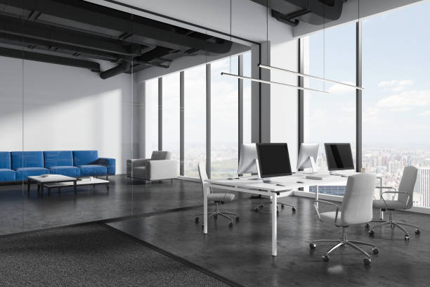 istock Modern office interior with pc computers and furniture, panoramic window 1861803698