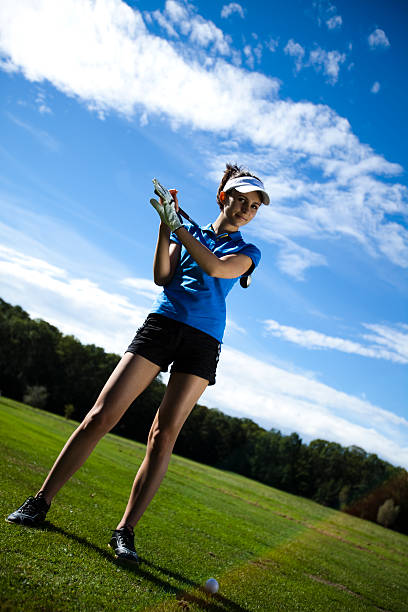 istock Woman playing golf on field 186181986