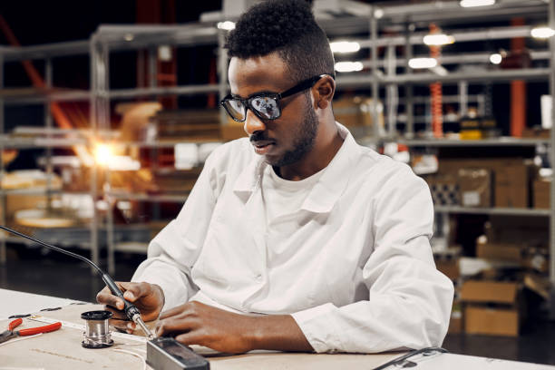 istock African engineer solderingled lamps at factory 1861821006