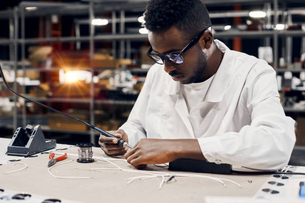 istock African engineer using soldering iron at factory 1861824599