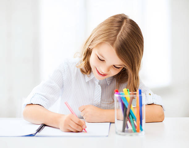istock little student girl drawing at school 186182474
